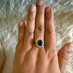 Adjustable Silver Ring with Deep Blue Center Stone and Halo